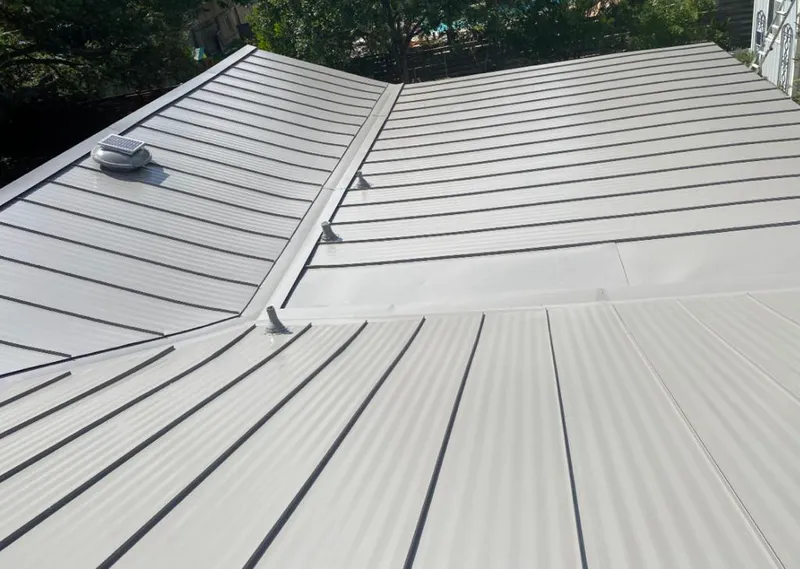 Solar attic fan installed on a metal roof for Roof Ventilation in Saline